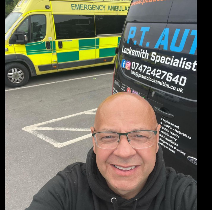 Paul of PT Auto Locksmiths on a job, alongside the signwritten PT Auto van.